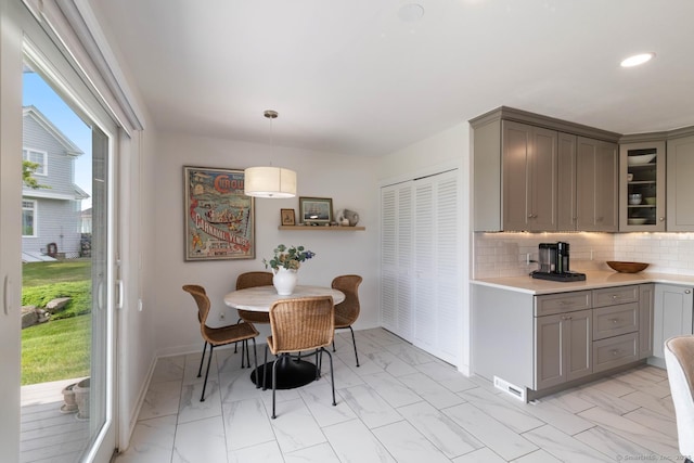 4 Old Fenwick Rd, Old Saybrook, CT 06475 - kitchen featuring gray cabinets, light marble finish flooring, light countertops, tasteful backsplash, and glass insert cabinets