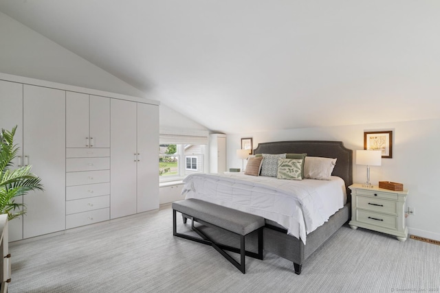 bedroom with visible vents and vaulted ceiling