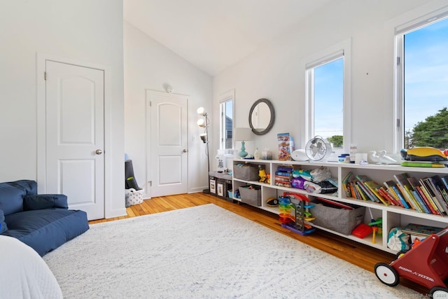 bedroom with lofted ceiling and light wood-style flooring