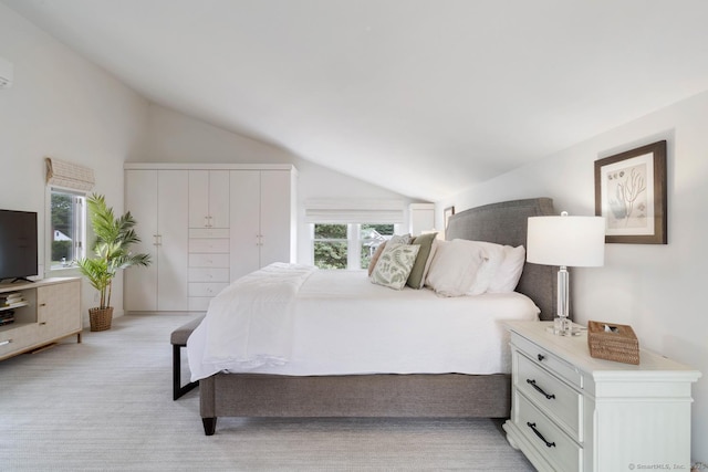 bedroom featuring vaulted ceiling and light carpet