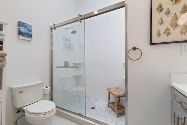 bathroom with toilet, marble finish floor, a shower stall, and vanity