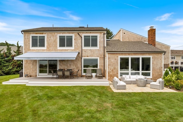 back of property featuring a yard, an outdoor living space, and a wooden deck