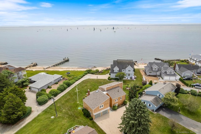 drone / aerial view featuring a water view and a residential view