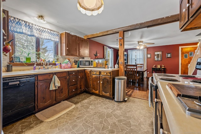 kitchen with a sink, black dishwasher, light countertops, electric range oven, and stainless steel microwave