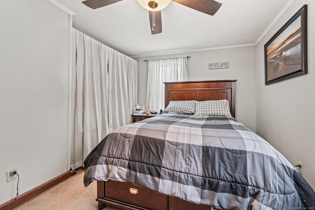 carpeted bedroom with baseboards, a ceiling fan, and crown molding