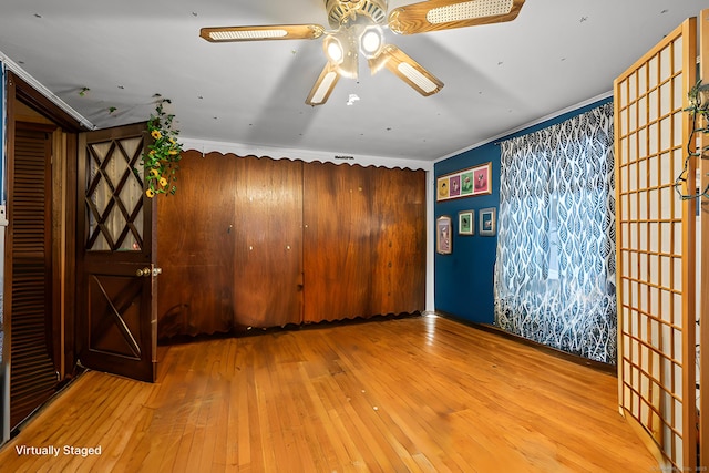 spare room with hardwood / wood-style flooring, ceiling fan, and ornamental molding