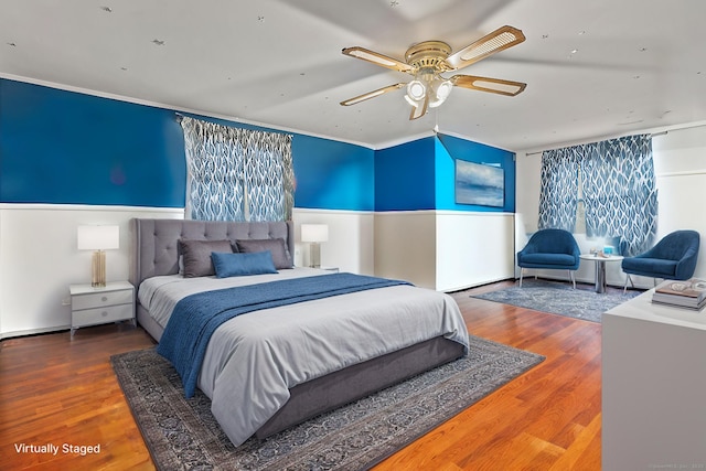 bedroom featuring wood finished floors, a ceiling fan, and crown molding