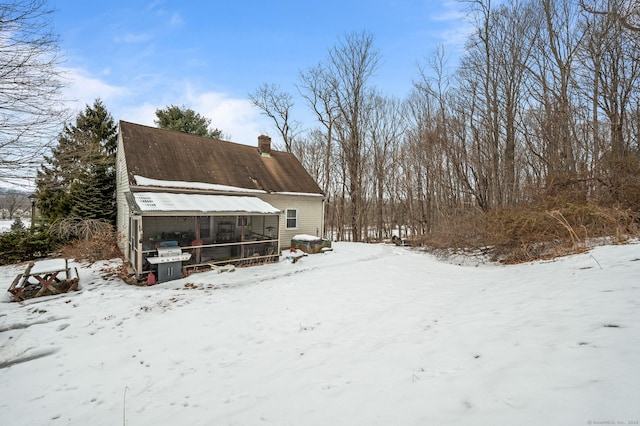 exterior space featuring a shingled roof and a chimney