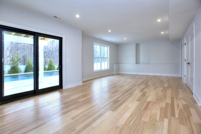 unfurnished room featuring baseboards, light wood-style flooring, and recessed lighting