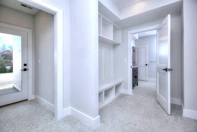 mudroom with carpet flooring, visible vents, and baseboards