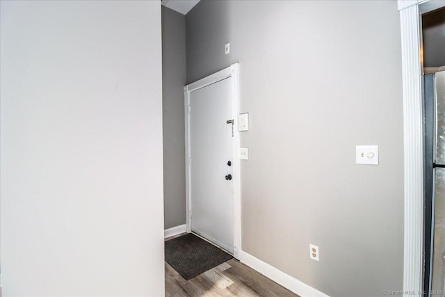 interior space featuring light wood-type flooring and baseboards