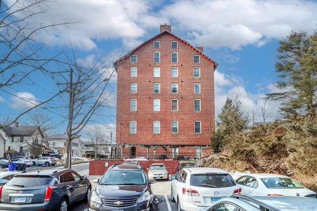 view of property featuring uncovered parking