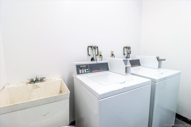 shared laundry area featuring a sink and washing machine and clothes dryer