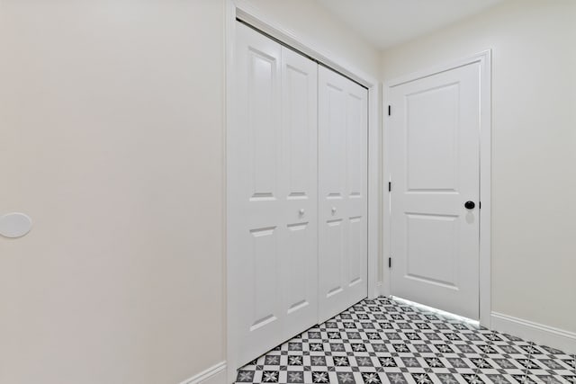 corridor with light floors and baseboards