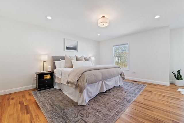 bedroom featuring recessed lighting, light wood-type flooring, and baseboards