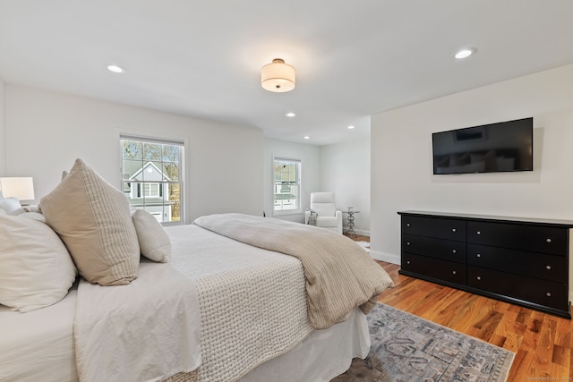 bedroom with recessed lighting, baseboards, and light wood finished floors