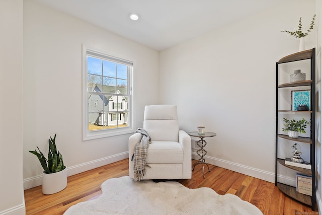 living area with recessed lighting, baseboards, and wood finished floors