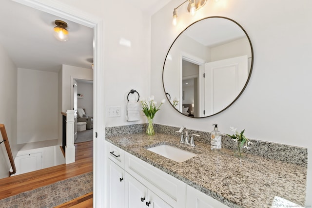 bathroom with wood finished floors and vanity