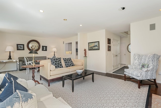 living area featuring baseboards and recessed lighting