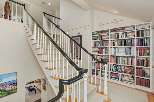 stairway featuring visible vents and lofted ceiling
