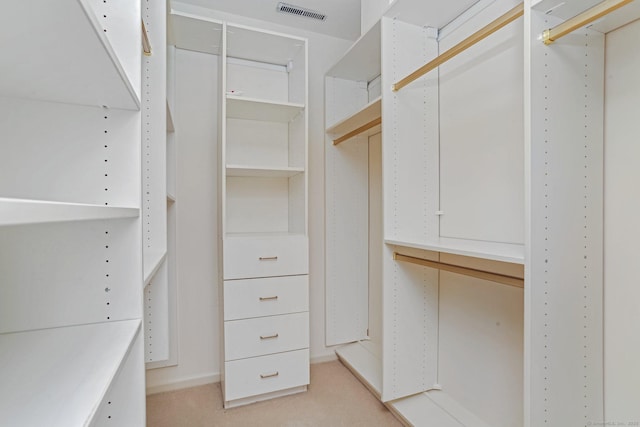 spacious closet with light colored carpet and visible vents