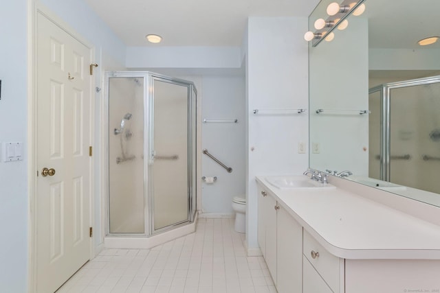 bathroom featuring vanity, tile patterned floors, a shower stall, and toilet