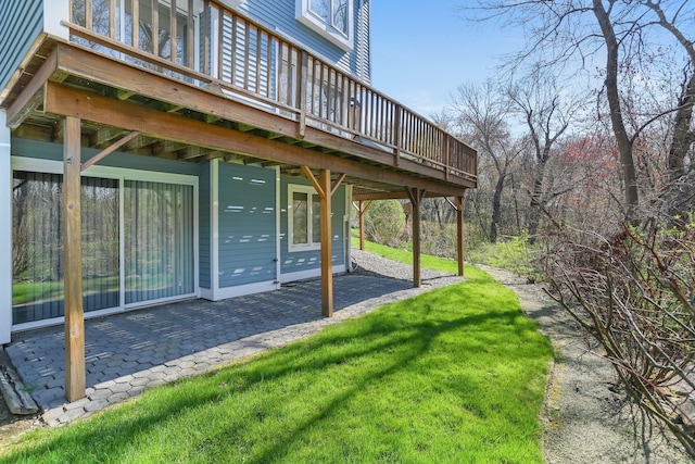 view of yard featuring a wooden deck and a patio