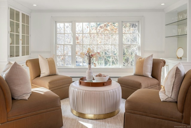 living room with crown molding, baseboard heating, recessed lighting, and a healthy amount of sunlight