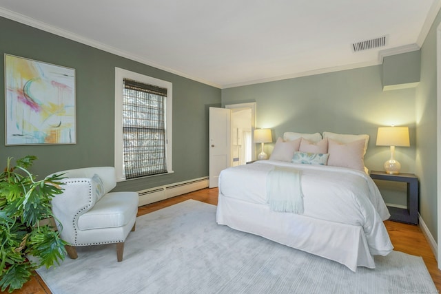 bedroom featuring ornamental molding, a baseboard radiator, wood finished floors, and visible vents