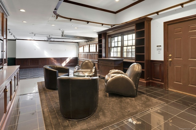 living area featuring a wainscoted wall, dark tile patterned flooring, ornamental molding, and recessed lighting