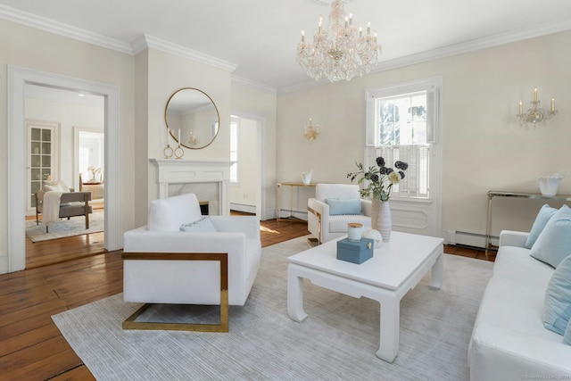 living room featuring crown molding, a fireplace, a baseboard radiator, light wood-style flooring, and a chandelier