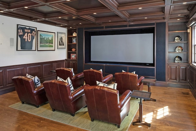 cinema room with built in shelves, coffered ceiling, wood finished floors, ornamental molding, and beam ceiling