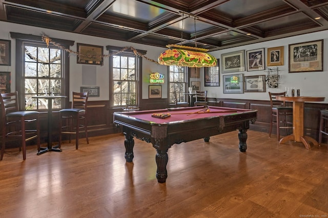 rec room with billiards, a wainscoted wall, wood-type flooring, a bar, and beam ceiling