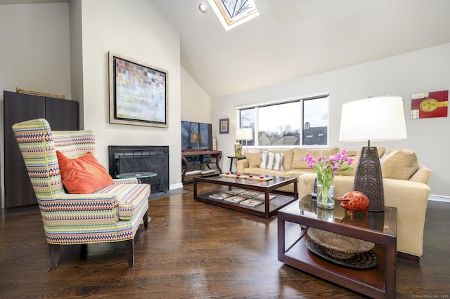 living area with a skylight, a fireplace with flush hearth, high vaulted ceiling, and wood finished floors