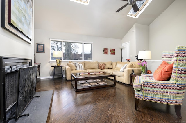 living room with a skylight, a ceiling fan, wood finished floors, high vaulted ceiling, and baseboards