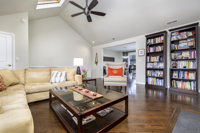 living room with high vaulted ceiling, wood finished floors, and visible vents