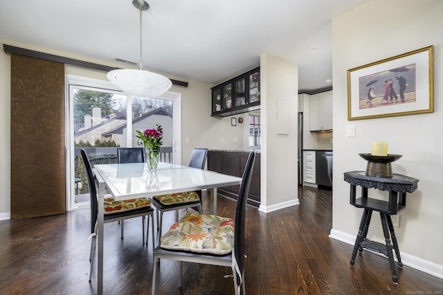 dining area with visible vents, dark wood finished floors, and baseboards