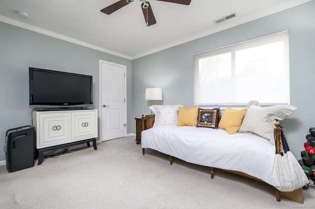 bedroom with ceiling fan, visible vents, crown molding, and carpet flooring