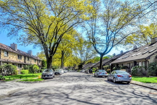 view of road featuring sidewalks, a residential view, and curbs