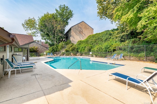 pool featuring a patio and fence