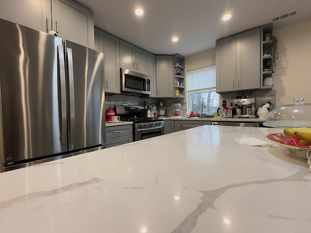 18 Soundview Ave, Norwalk, CT 06854 - kitchen featuring open shelves, visible vents, gray cabinets, a sink, and stainless steel appliances
