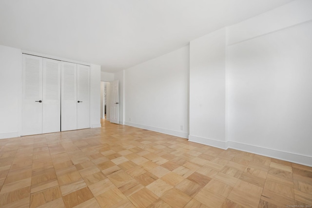 unfurnished bedroom with a closet and baseboards