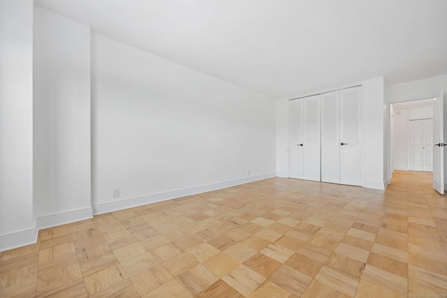 unfurnished bedroom featuring a closet and baseboards