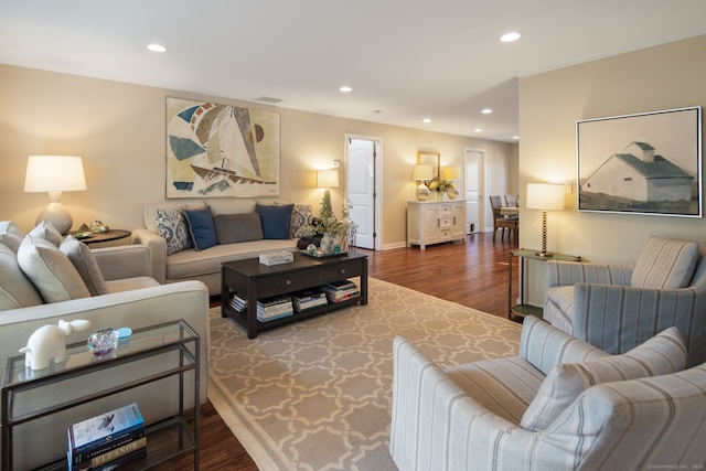 living room with baseboards, wood finished floors, and recessed lighting