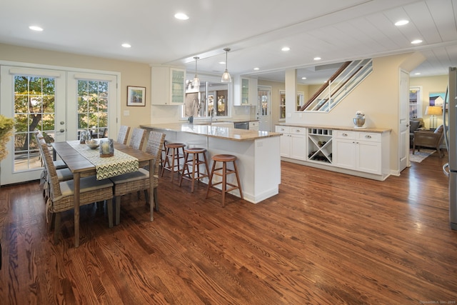 dining area with baseboards, french doors, dark wood-type flooring, and recessed lighting