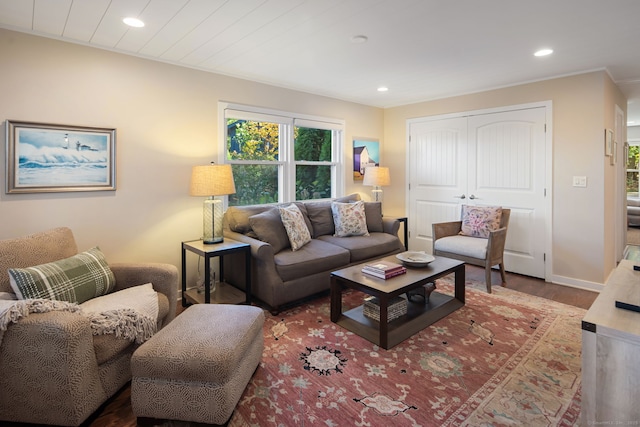 living area with recessed lighting, baseboards, and wood finished floors