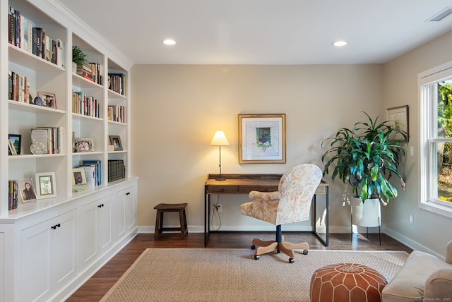 home office featuring baseboards, visible vents, dark wood-type flooring, and a wealth of natural light