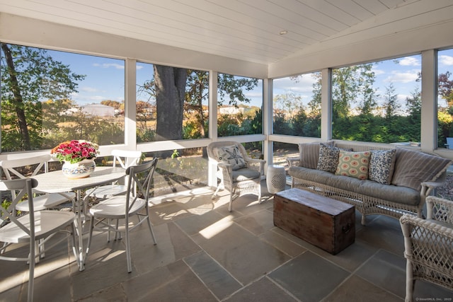 sunroom featuring lofted ceiling and wooden ceiling