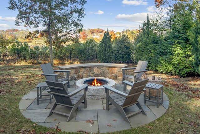 view of patio with a forest view and a fire pit