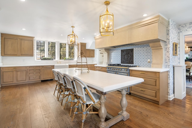 kitchen featuring a chandelier, light countertops, double oven range, and light wood finished floors